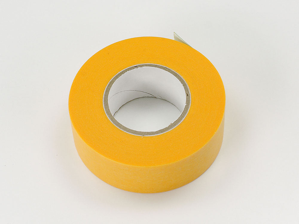 A roll of Tamiya brand yellow masking tape, 18mm in width, with a visible brand logo on the inner core.