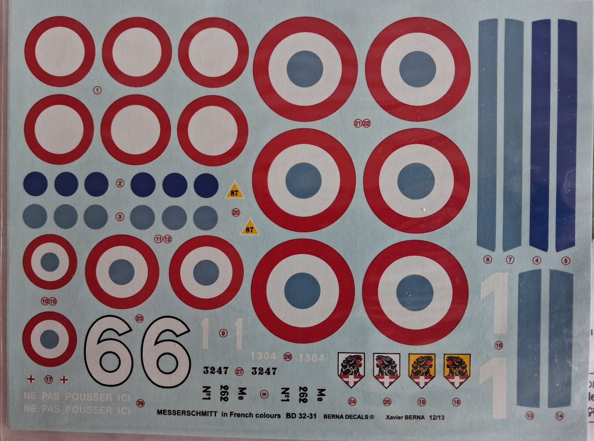 Sheet of decal stickers with red, white, and blue circular patterns on a gray background