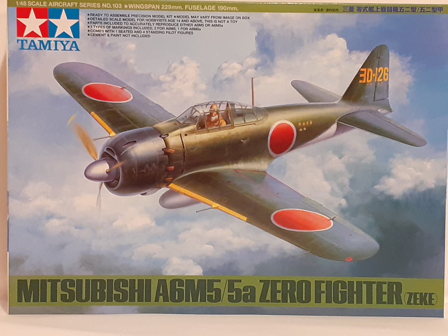 Tamiya 1:48 scale model kit of Mitsubishi A6M5/5a Zero Fighter (Zeke) aircraft, showing the box packaging with the plane depicted on it.