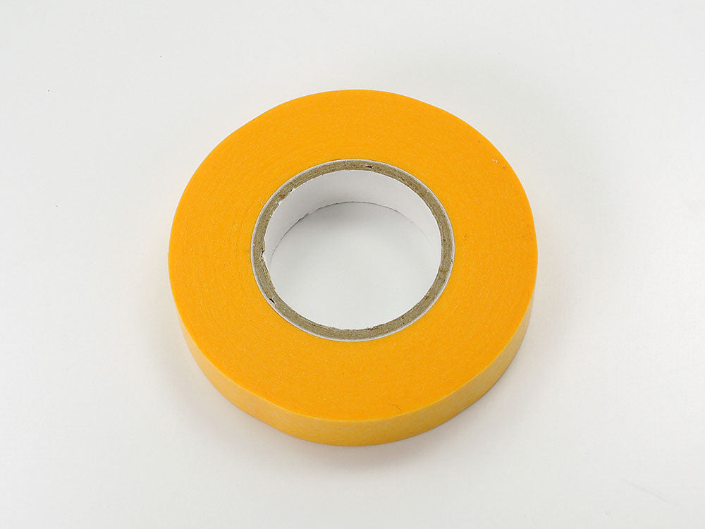 A roll of Tamiya brand yellow masking tape, 10mm wide, used for precision masking work on models.