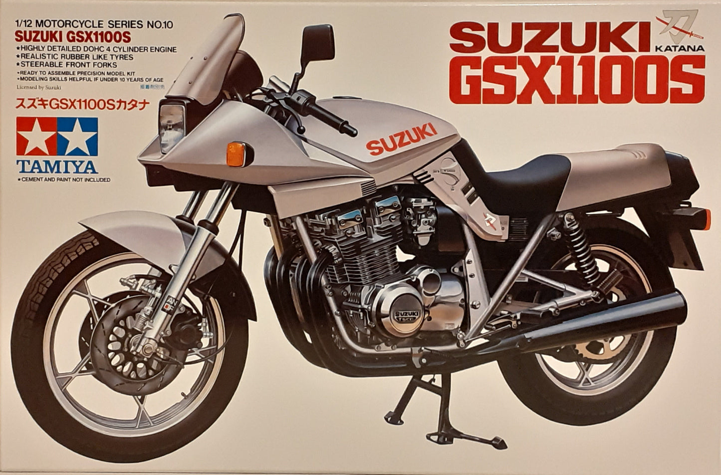 A 1:12 scale model of a Suzuki GSX1100S motorcycle, featuring a gray body, black and silver detailing, and realistic rubber-like tires.