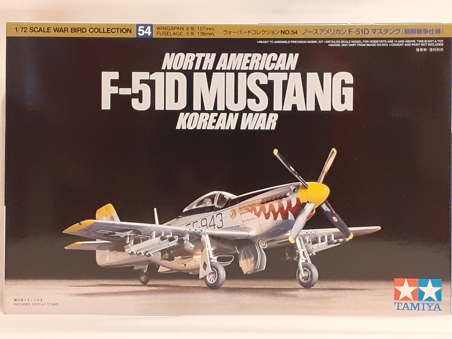 A Tamiya 1:72 scale model kit of the North American F-51D Mustang in a Korean War scheme, including the box packaging with historical text and an image of the aircraft.
